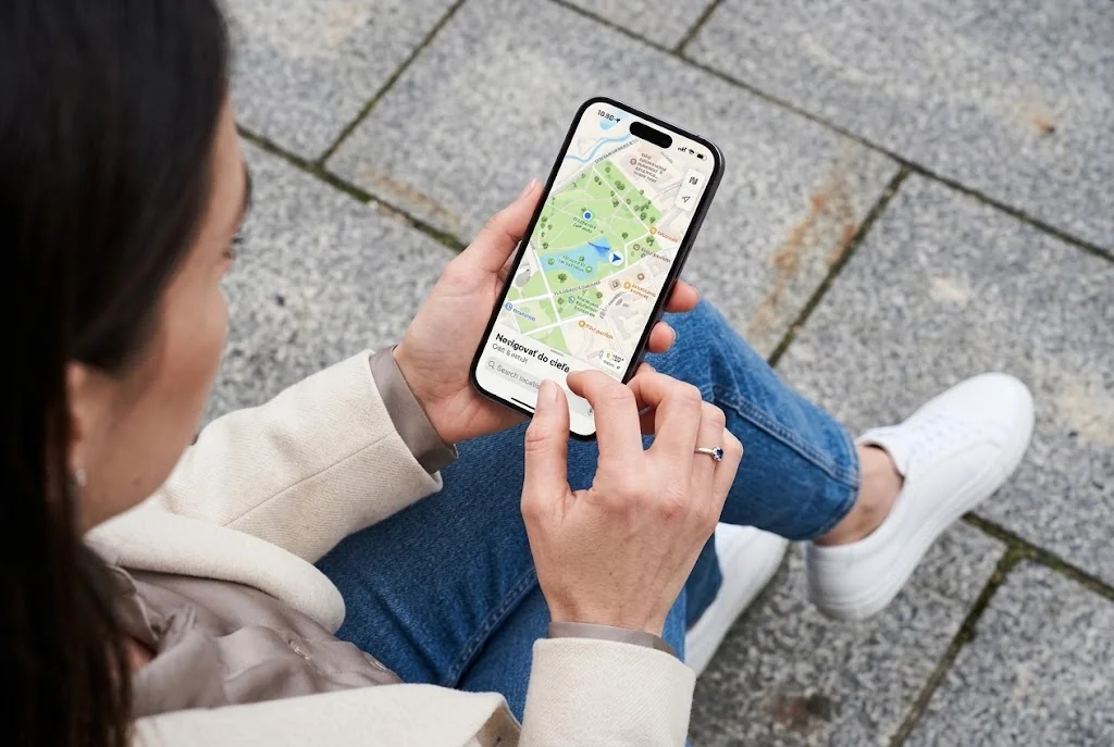 Woman checking a map on her phone on a sidewalk